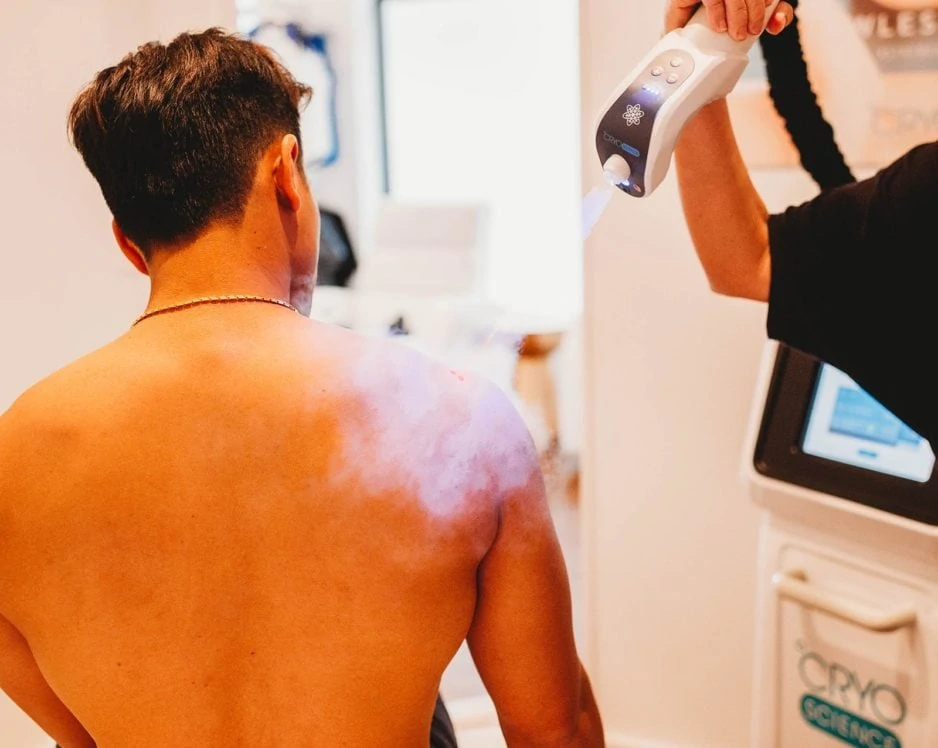 Man receiving Localized Spot Cryotherapy treatment on shoulder and upper back.