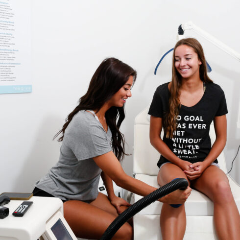 Female receiving localized cryotherapy service for her knee at Degree Wellness
