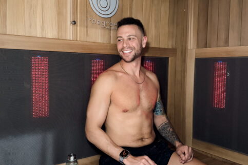 Man relaxing in his private infrared sauna after a long week